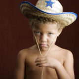 sad boy in sheriff hat